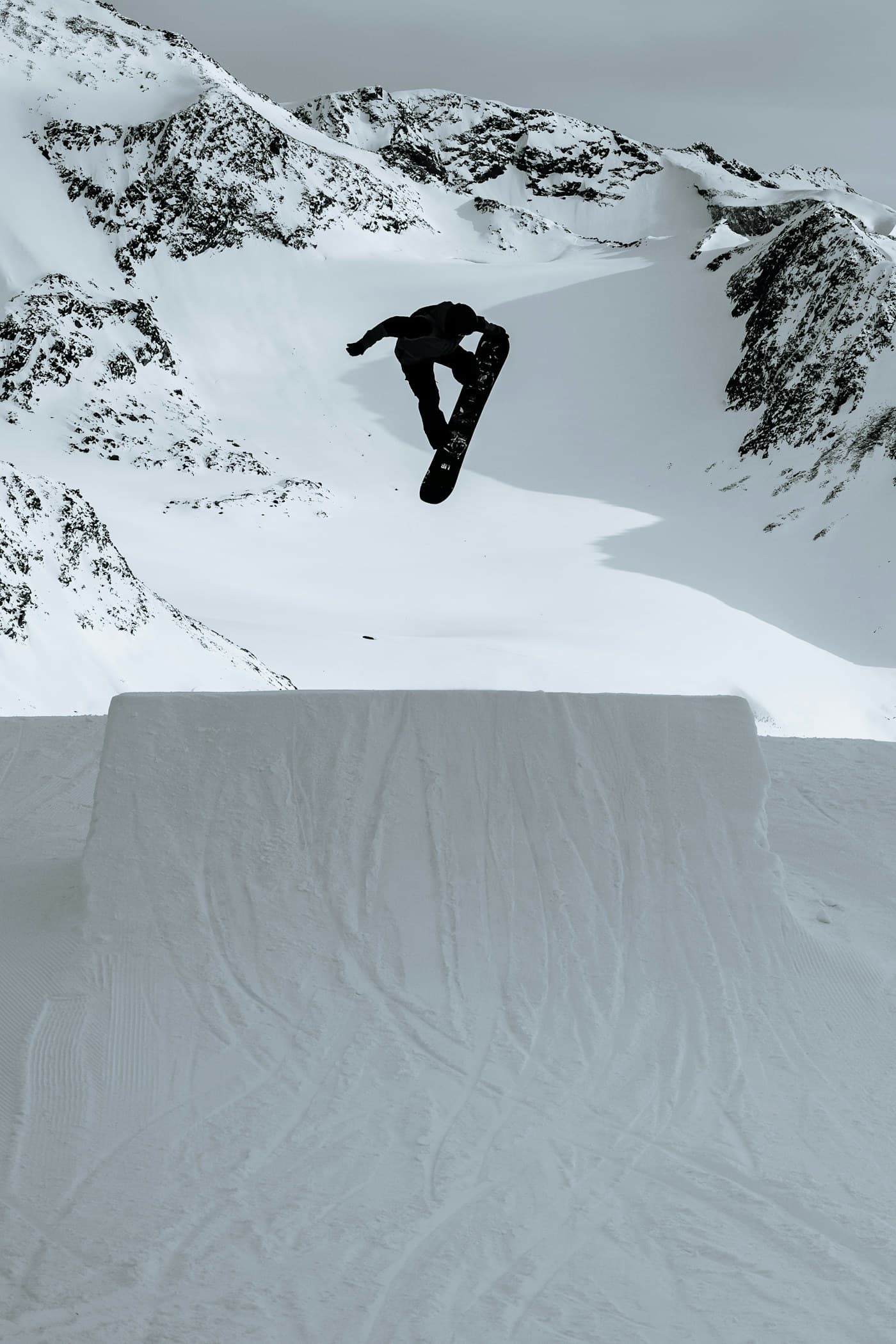A snowboarder riding fresh mountain snow
